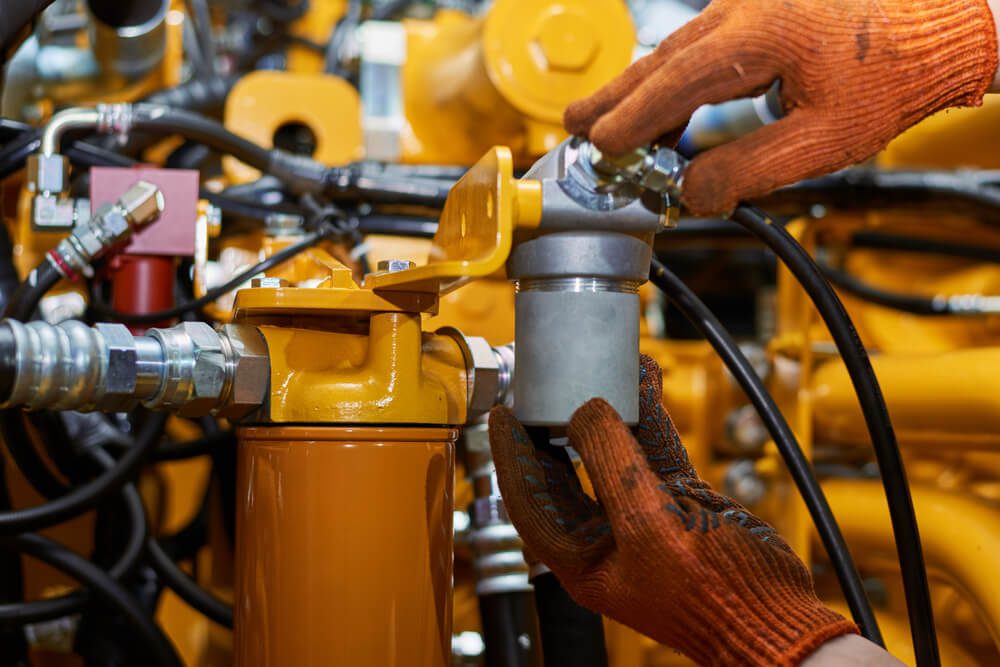 Banner with close up view of hydraulic pipes of heavy industry machine. Low key. Hydraulic maintenance concept.